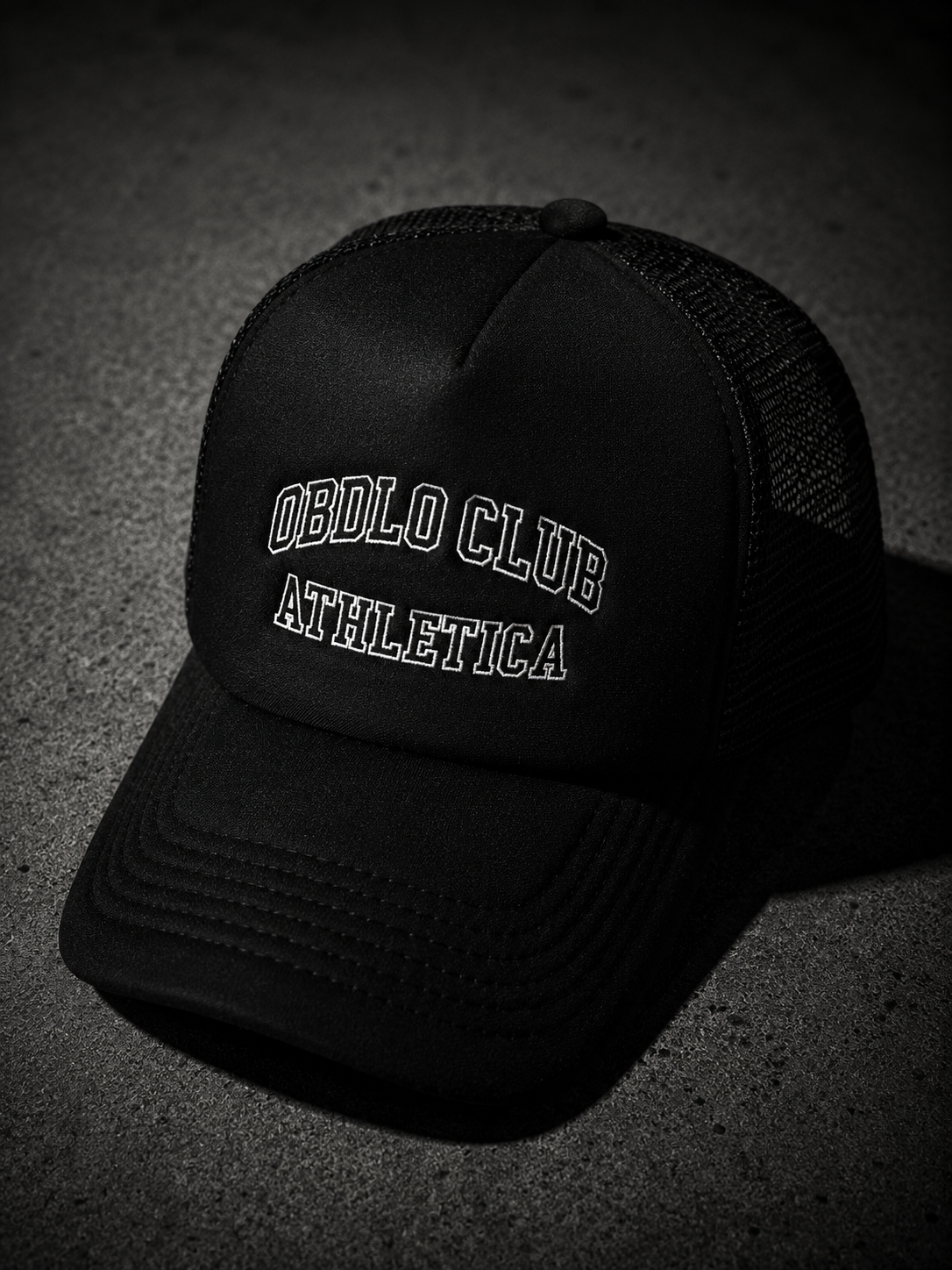 Black cap with 'OBLO CLUB ATHLETICA' text on a dark background