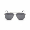 Aviator sunglasses with black lenses on a wooden surface